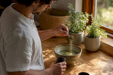 Man pouring herbal supplement into glass