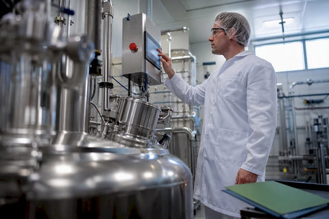 Quality specialist inspecting supplement manufacturing controls