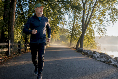Man briskly walking on a sunlit park path