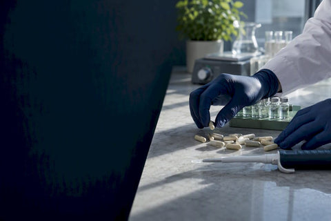 Researcher measuring supplement samples in laboratory