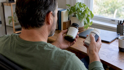 Shopper comparing supplement dosage labels