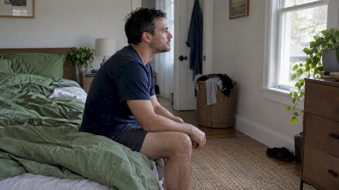 Man waking quietly in his bedroom