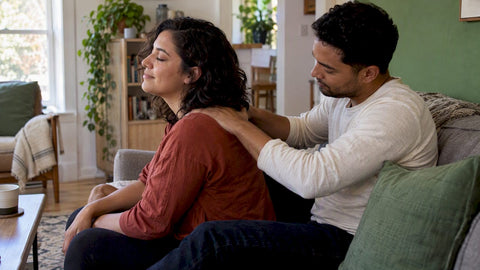 Partners sharing a gentle back rub at home